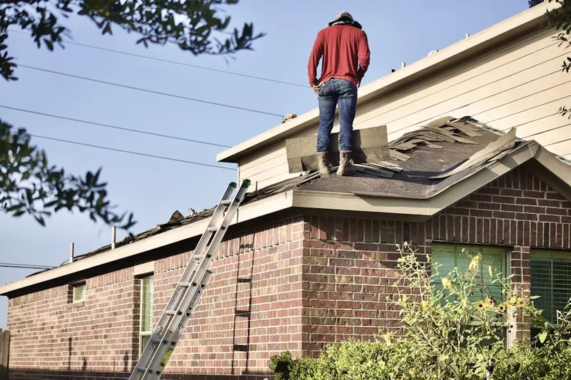 Professional roofer working on a residential roof in Woodinville